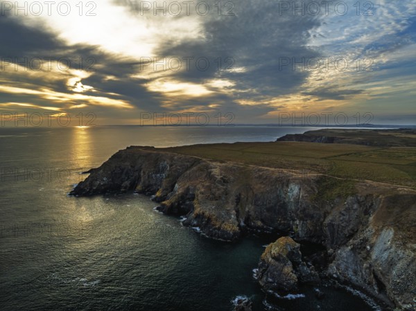 Sunset over Kynance Cove from a drone, Mount's Bay, Lizard Point, Cornwall, England, United Kingdom
