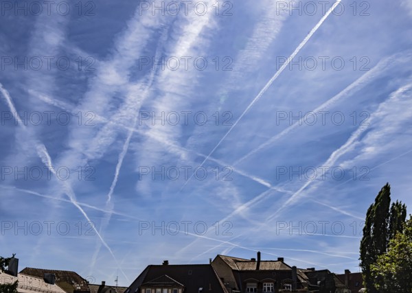 Contrails in the sky. These artificial clouds are created from the exhaust fumes of aeroplanes. But there are also conspiracy theory myths. Stuttgart, Baden-Württemberg, Germany
