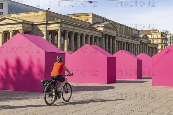 Twelve houses in bright magenta stand on Stuttgart's Schlossplatz in front of the art museum. The Pforzheim-based architecture artist Andreas Sarow developed the Exkursion art project. Stuttgart, Baden-Württemberg, Germany