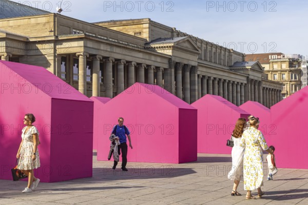 Twelve houses in bright magenta stand on Stuttgart's Schlossplatz in front of the art museum. The Pforzheim-based architecture artist Andreas Sarow developed the Exkursion art project. Stuttgart, Baden-Württemberg, Germany
