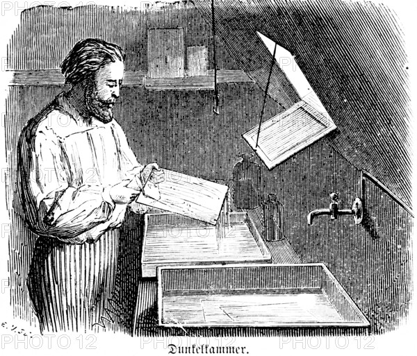 Darkroom, exposure of negatives on photographic paper, development of photos, glass, liquids, fixir bath, developer, water, tap, darkness, red light, dark room, man with beard, photographer, artist, inventions in the 19th century, technology, photography, historical illustration 1872, Germany