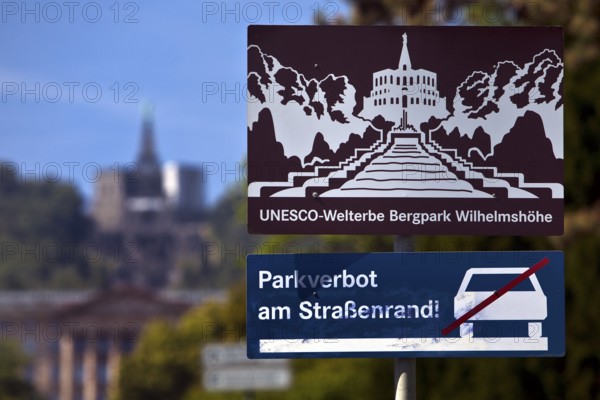 Bergpark Wilhelmshöhe, sharp sign with park prohibition notice and blurred Hercules building, Kassel, Hesse, Germany