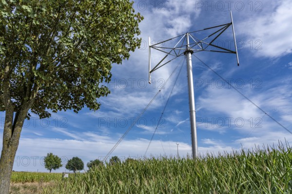 Vertical axis wind turbine, Darrieu wind turbine, 2 vertically mounted rotors rotate around the axis, near Darup in Münsterland, North Rhine-Westphalia, Germany