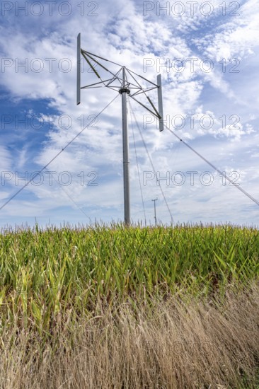Vertical axis wind turbine, Darrieu wind turbine, 2 vertically mounted rotors rotate around the axis, near Darup in Münsterland, North Rhine-Westphalia, Germany