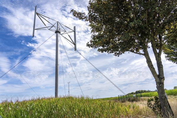 Vertical axis wind turbine, Darrieu wind turbine, 2 vertically mounted rotors rotate around the axis, near Darup in Münsterland, North Rhine-Westphalia, Germany