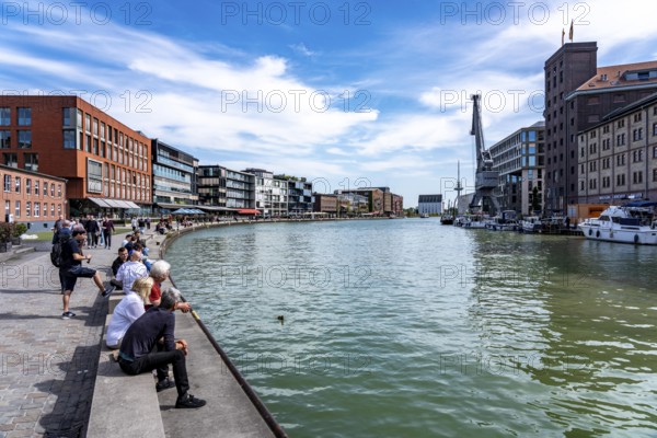 Münster's harbour district, known as Kreativkai, a lively quarter that has developed from a former goods handling area into a modern hotspot for art, culture, gastronomy and business, in converted warehouses combined with modern architecture, nightlife district, former inner harbour, on the Dortmund-Ems Canal, North Rhine-Westphalia, Germany