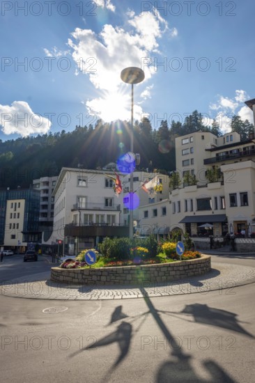 Roundabout in City and with Blue Sky and Clouds with Sunbeam in a Sunny Summer Day in St Moritz, Grisons, Switzerland