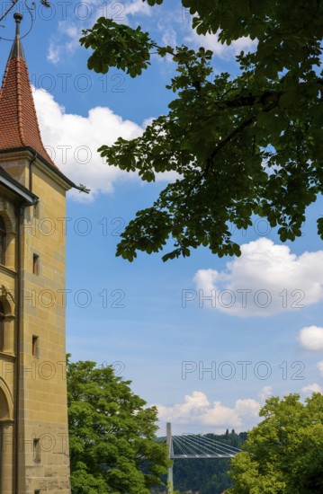 House with Tower and Beautiful Bridge and Tree Branch in a Sunny Summer Day in City of Fribourg, Canton Fribourg, Switzerland