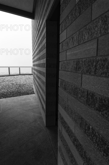 Modern Building with a Door Entrance and Sunlight in a Cloudy Day in Monte Generoso, Ticino, Switzerland