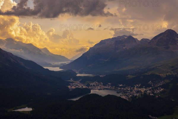 Beautiful Aerial View over Five Lakes and Swiss Alps and Cityscape in Sunset and Storm Clouds over St Moritz, Maloja, Grisons, Switzerland
