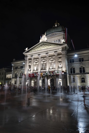 Beautiful Bundeshaus Illuminated Parliament Building or Federal Palace with Water Fountain on Bundesplatz at Night in City of Bern, Bern Canton, Switzerland
