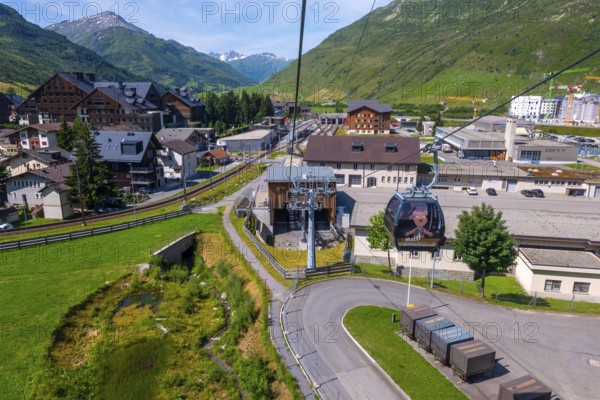 Beautiful View From Overhead Cable Car and Station and over Cityscape and Railroad Station with Mountainscape and Mountain Valley in the Swiss Alps in a Sunny Summer Day in Andermatt, Uri, Switzerland