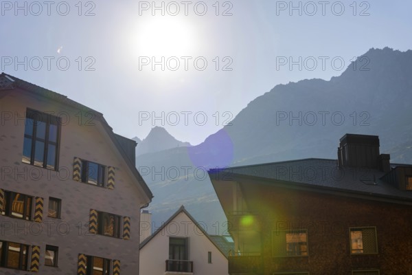Beautiful Modern Building Against Blue Clear Sky and Mountain in a Sunny Summer Day with Sunlight in Andermatt, Uri, Switzerland