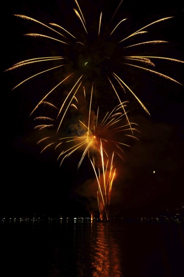 Beautiful Fireworks Display at Night over Lake Lugano in Ponte Tresa, Lombardy, Italy