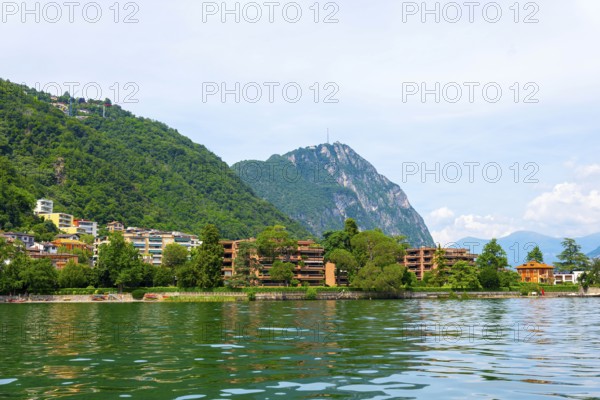 Elegant Building on the Mountain Side in a Sunny Summer Day on the Waterfront to Lake Lugano in Melide, Lugano, Ticino, Switzerland