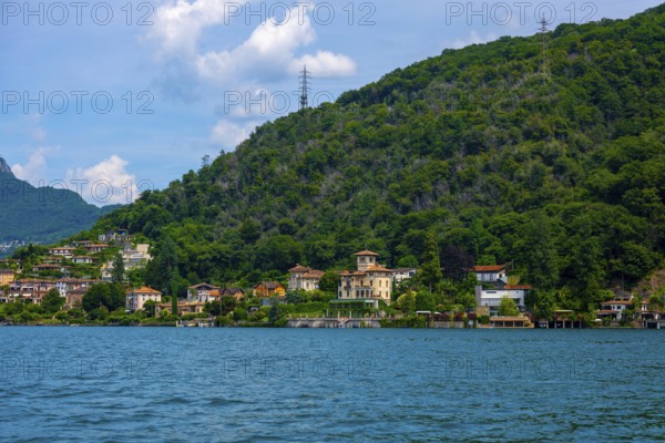 House and Mountain Range in a Sunny Summer Day on the Waterfront to Lake Lugano in Figino, Lugano, Ticino, Switzerland