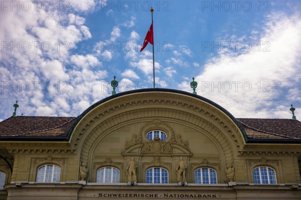 Beautiful Swiss National Bank with Flag in a sunny Day with Blue Sky and Clouds in City of Bern, Bern Canton, Switzerland