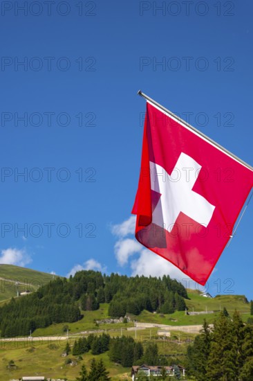 Beautiful Swiss Flag Against Mountain in the Swiss Alps in a Sunny Summer Day in Andermatt, Uri, Switzerland