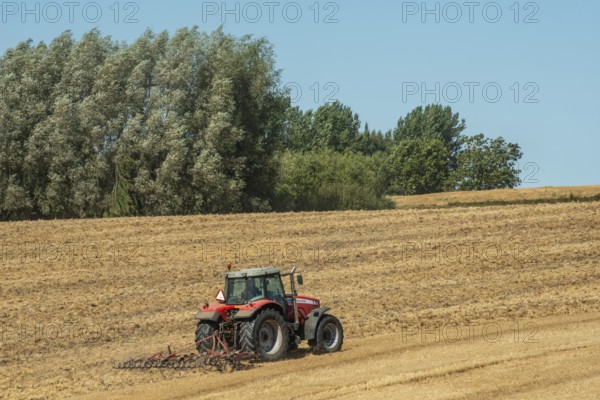 Autumn harrowing with tractor in Borrie, Ystad municipality, Skåne county, Sweden, Scandinavia