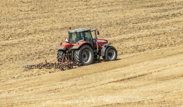 Autumn harrowing with tractor in Borrie, Ystad municipality, Skåne county, Sweden, Scandinavia