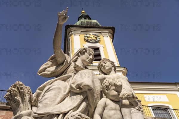 Group of figures of Mother Baar and the Catholic Church of St John in Donaueschingen, Baden-Württemberg, Germany