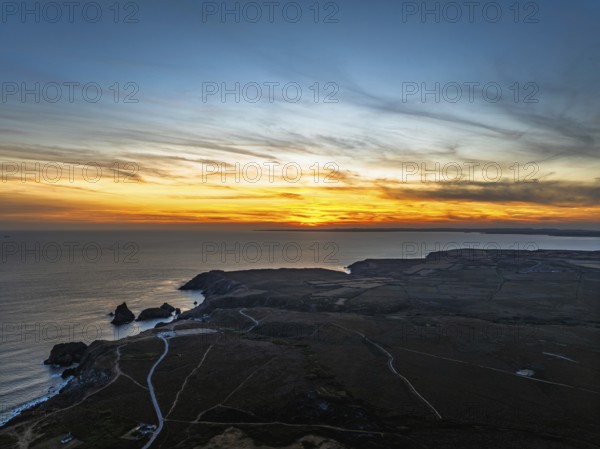 Sunset over Kynance Cove from a drone, Mount's Bay, Lizard Point, Cornwall, England, United Kingdom
