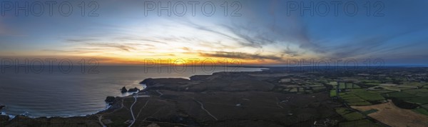Sunset over Kynance Cove from a drone, Mount's Bay, Lizard Point, Cornwall, England, United Kingdom