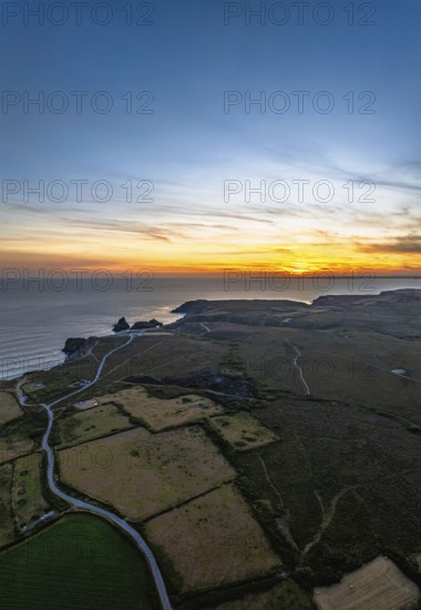 Sunset over Kynance Cove from a drone, Mount's Bay, Lizard Point, Cornwall, England, United Kingdom