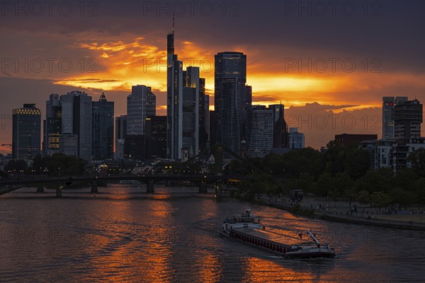 The sun breaks through the clouds behind the Frankfurt banking skyline shortly in front of setting, Frankfurt am Main, Hesse, Germany