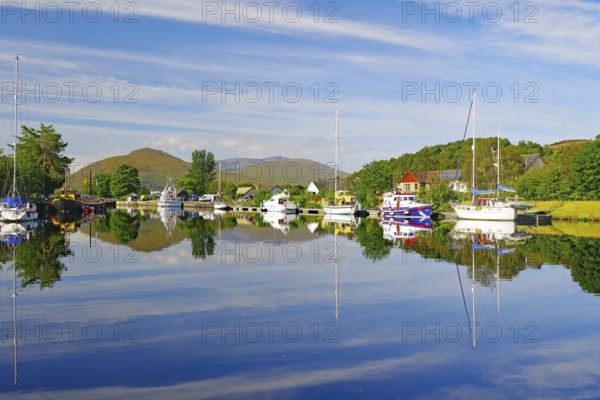 Calm river landscape with anchored boats and clear reflections, Caledonian Canal, Fort William, Highlands, Highlands, Scotland, Great Britain