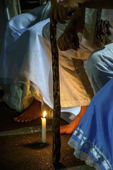 Moment of prayer illuminated by candles in a religious ceremony of Umbanda, Belo Horizonte, Minas Gerais, Brazil