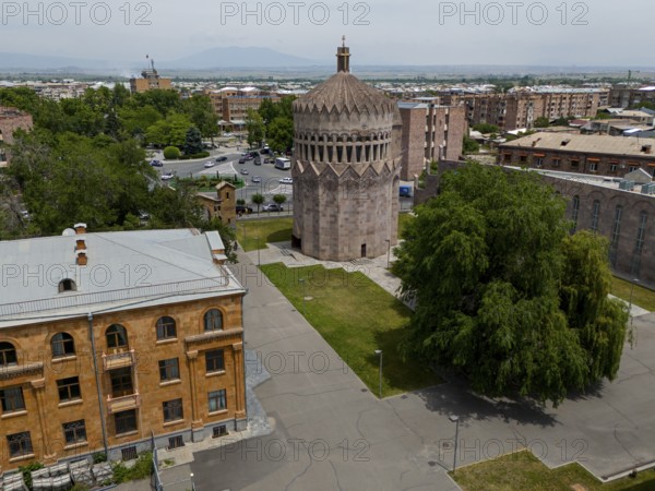 A round tower in an urban setting with surrounding trees and historic buildings, aerial view, Holy Archangel Church, Echmiadzin, Echmiadzin, Ejmiacin, Vagharshapat, Vagarshapat, Vagarshapat, Vagharshapat, Armavir Province, Armenia