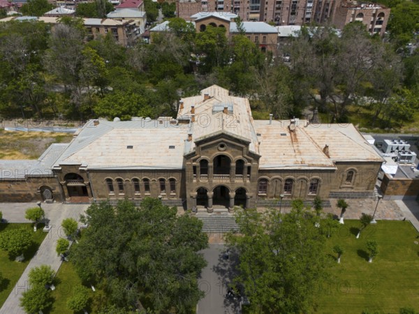 Historic building with classical façade surrounded by lush vegetation and urban area, aerial view, Christian Education Centre, Echmiadzin, Echmiadzin, Ejmiacin, Vagharshapat, Vagarshapat, Vagarshapat, Vagharshapat, Armavir Province, Armenia