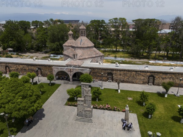 Historic church and monument in a green park with people in an urban setting, aerial view, St Vardan and St Hovhannes Chapel-Baptistery, Echmiadzin, Echmiadzin, Ejmiacin, Vagharshapat, Vagharshapat, Vagharshapat, Valaršapat, Vagharshapat, Armavir Province, Armenia