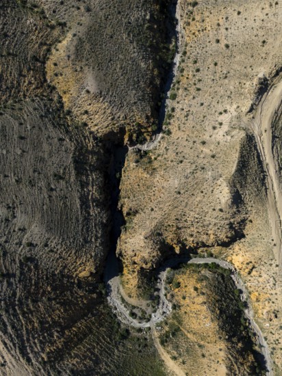 Vertical shot of a dry, rocky canyon with a narrow path, aerial view, Angel's Canyon, canyon, Dashtakar, Ararat province, Armenia