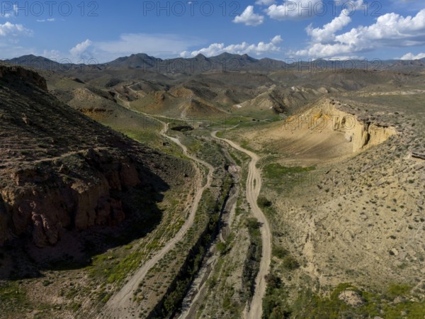 View over a vast desert landscape with mountains and a valley under a cloudy sky, aerial view, on the way to Angel's Canyon, Dashtakar, Ararat Province, Armenia