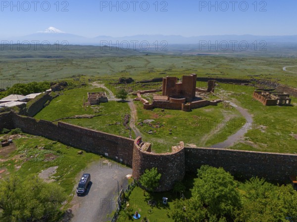 View of a lonely ancient fortress in a vast landscape with a distant mountain, Dashtadem Fortress, Qagheni Fortress, Dashtadem village, in the background Mount Ararat in Turkey, Aragatsotn Province, Armenia