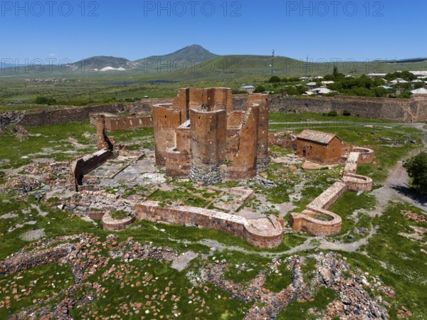 Ruins of an old brick fortress in the middle of a green landscape with mountains in the background, aerial view, Dashtadem Fortress, Qagheni Fortress, Dashtadem village, Aragatsotn Province, Armenia Asia