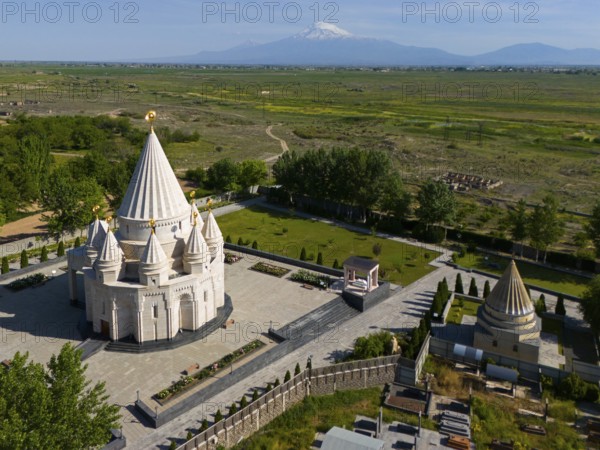 Religious temple in picturesque landscape with mountains in the background and calm atmosphere, aerial view, Yazidi temple, the largest Yazidi temple in the world is called Quba Mere Diwane, Aknalich, Aknalich, Armavir district, in the background Mount Aarat in Turkey, Armenia