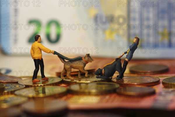 Miniature figure of man and woman with dogs and cash, North Rhine-Westphalia, Germany
