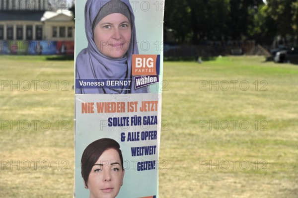 Posters for the North Rhine-Westphalia municipal election campaign in Bonn around the Hofgarten in the university district. Poster of the Stimme Bonn International (SBI) party calling for fewer refugees through fewer wars - send food instead of weapons