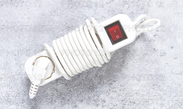 Power cord with switch and coiled design for easy storage in household or office settings