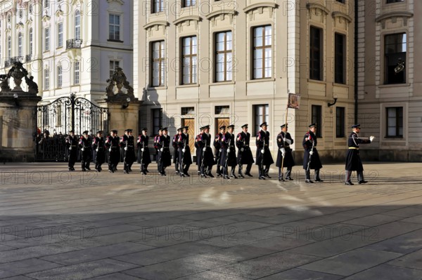 Changing of the guard at Prague Castle, Hradcany, Prague, Czech Republic, Europe, Group of soldiers in uniform marching in formation in front of a historic building