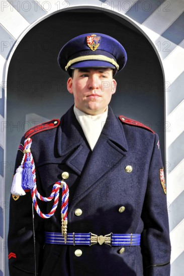 Changing of the guard at Prague Castle, Hradcany, Prague, Czech Republic, Europe, Soldier in blue uniform stands upright in front of a decorative guardhouse