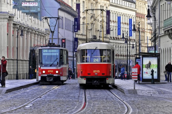 Trams on the move in the city centre, Prague, Two trams in motion on a busy city street in Prague, Prague, Czech Republic