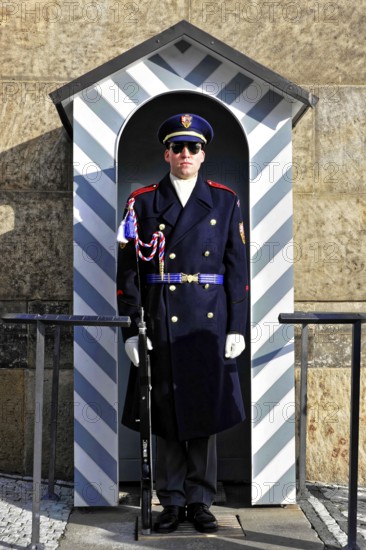 Changing of the guard at Prague Castle, Hradcany, Prague, Czech Republic, Europe, A uniformed soldier stands in a guard hut decorated in shades of blue and white
