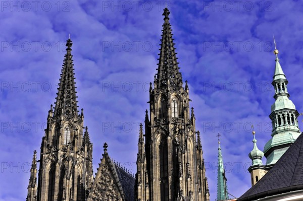St Vitus or St Vitus Cathedral, Hradcany, Prague, Czech Republic, Europe, Two Gothic church towers rise into the cloudy blue sky