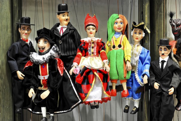 Prague marionettes, Prague, Czech Republic, Europe, Various marionettes with colourful costumes, hanging on a wooden base for display