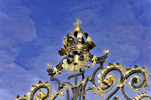 Prague, Czech Republic, Europe, Detailed decorated Tor tor with golden crown and cross in front of a cloudy sky