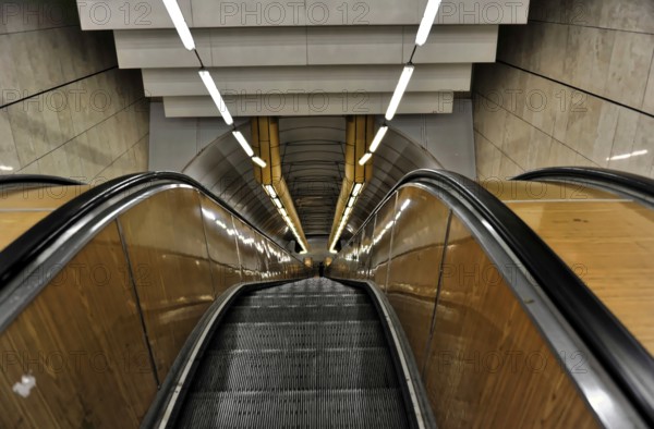 Prague, Czech Republic, Europe, Long escalator in a modern, symmetrical tunnel design
